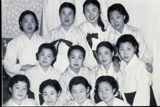 A group of women posing for a photo

Description automatically generated